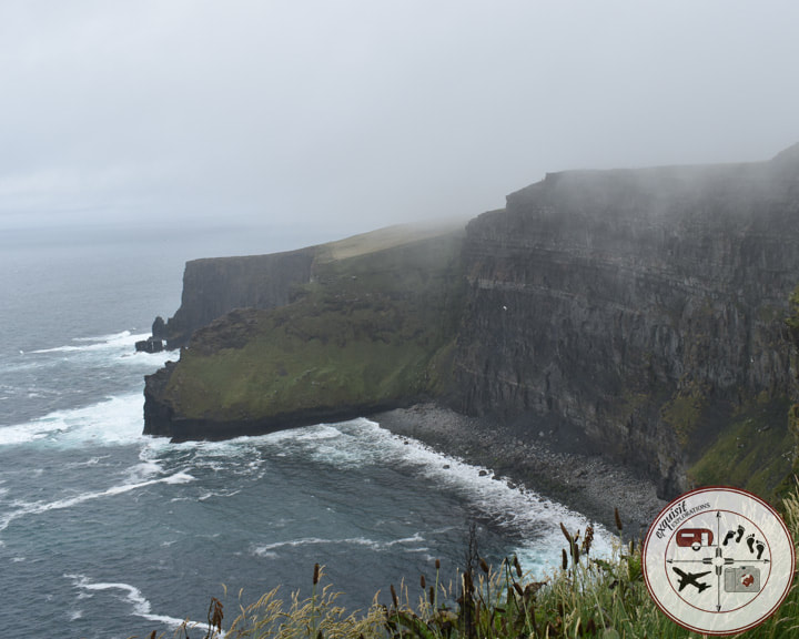 Fog nearly lifted over the Cliffs of Moher in Ireland; must-see places in Ireland